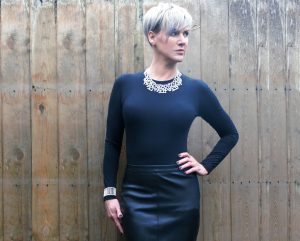 Chester Classic Round Neck Top worn with faux leather skirt and statement jewellery